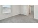 Comfortable bedroom featuring soft carpet, neutral walls, and a window providing natural light at 10823 Penny Gale Loop, San Antonio, FL 33576