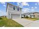 Side view of a two-story home with a large driveway and manicured lawn at 10823 Penny Gale Loop, San Antonio, FL 33576