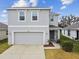 Two-story home featuring a two-car garage and freshly landscaped yard at 10823 Penny Gale Loop, San Antonio, FL 33576