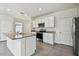 Modern kitchen with stainless steel appliances, granite countertops, and ample cabinet space at 10823 Penny Gale Loop, San Antonio, FL 33576