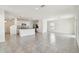 Spacious, open floor plan showing a staircase, kitchen, and large tile flooring at 10823 Penny Gale Loop, San Antonio, FL 33576