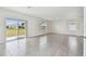Bright living room with tile floors and sliding doors to the backyard offers a seamless indoor-outdoor living experience at 10823 Penny Gale Loop, San Antonio, FL 33576