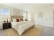 Serene main bedroom with large windows, neutral tones, walk-in closet and plush carpeting for ultimate relaxation at 10823 Penny Gale Loop, San Antonio, FL 33576