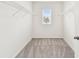 Large walk-in closet with wire shelving and natural light from the window at 10823 Penny Gale Loop, San Antonio, FL 33576