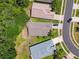 Aerial view of roofs of homes in a neighborhood setting with landscaped yards and a parked car at 1119 Dustan Pl, Trinity, FL 34655