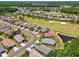 Aerial view of a golf community featuring well-maintained homes, lush fairways, and sparkling ponds, offering a luxurious lifestyle at 1119 Dustan Pl, Trinity, FL 34655
