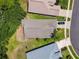 Aerial view showcases the home's roof and surrounding lush green landscape and neighborhood streetscape at 1119 Dustan Pl, Trinity, FL 34655