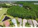 Aerial view of homes near a golf course and pond, surrounded by mature trees and lush landscaping in a lovely community at 1119 Dustan Pl, Trinity, FL 34655