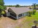 Aerial view of home showing spacious backyard with screened-in patio and lush green landscaping at 1119 Dustan Pl, Trinity, FL 34655