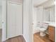 Bright bathroom features a tub-shower combination, wood-look vinyl flooring and single-sink vanity at 1119 Dustan Pl, Trinity, FL 34655