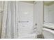 Close up of the bathtub with shower in the bright, neutral toned bathroom at 1119 Dustan Pl, Trinity, FL 34655