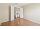 Bedroom with open doorway views the kitchen, vinyl flooring, and neutral walls at 1119 Dustan Pl, Trinity, FL 34655