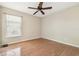 Neutral bedroom with vinyl flooring, ceiling fan, and a window for natural light at 1119 Dustan Pl, Trinity, FL 34655