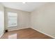 Empty bedroom with neutral walls, laminate flooring, and one window at 1119 Dustan Pl, Trinity, FL 34655