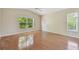 Bright bedroom with wood floors, vaulted ceilings, a ceiling fan, and two large windows overlooking backyard at 1119 Dustan Pl, Trinity, FL 34655