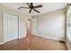 The neutral bedroom features vinyl flooring, ceiling fan, and walk in closet at 1119 Dustan Pl, Trinity, FL 34655