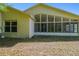 Back exterior showcasing the sunroom with multiple windows at 1119 Dustan Pl, Trinity, FL 34655