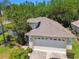 Aerial view of a well-maintained home featuring a two-car garage and manicured landscaping at 1119 Dustan Pl, Trinity, FL 34655