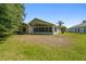 Rear view of the home showcasing the sunroom and spacious backyard at 1119 Dustan Pl, Trinity, FL 34655