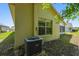 Exterior side view of the home, showing the air conditioning unit at 1119 Dustan Pl, Trinity, FL 34655
