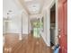 Bright foyer with wood flooring, an arched doorway, and a laundry room with a washer and dryer at 1119 Dustan Pl, Trinity, FL 34655