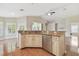 Kitchen island featuring a stainless steel dishwasher and countertop with a view to the living room at 1119 Dustan Pl, Trinity, FL 34655