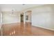 Large, well-lit living room showcasing wood flooring, arched doorways, and plenty of open space at 1119 Dustan Pl, Trinity, FL 34655