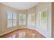 Bright and airy living room with wood flooring and plantation shutters on the windows at 1119 Dustan Pl, Trinity, FL 34655