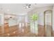 Open-concept living space features wood floors, kitchen with breakfast bar, and sliding door to screened porch at 1119 Dustan Pl, Trinity, FL 34655