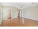Main bedroom with wood floors and ensuite bathroom with access to the kitchen and a walk-out to the backyard at 1119 Dustan Pl, Trinity, FL 34655