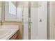 Shower with glass doors and a white tiled surround at 1119 Dustan Pl, Trinity, FL 34655