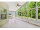 Bright sunroom with tile flooring and large windows offering beautiful outdoor views at 1119 Dustan Pl, Trinity, FL 34655