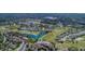 Aerial view of the Heritage Pines community featuring homes, golf course, and a pond at 11213 Brooklawn Dr, Hudson, FL 34667