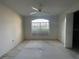 Bedroom featuring a large arched window with lots of natural light and a ceiling fan at 11213 Brooklawn Dr, Hudson, FL 34667