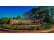 The Heritage Pines community entrance features lush landscaping and a brick sign at 11213 Brooklawn Dr, Hudson, FL 34667