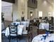 The dining room features nicely appointed tables and chairs with a cozy fireplace at 11213 Brooklawn Dr, Hudson, FL 34667
