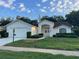 Charming single-story home with a well-maintained lawn, double door entry, and attached two-car garage at 11213 Brooklawn Dr, Hudson, FL 34667