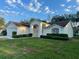 Charming single-story home with a well-maintained lawn, double door entry, and attached two-car garage at 11213 Brooklawn Dr, Hudson, FL 34667
