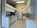 Bright eat-in kitchen featuring white appliances, ample cabinet space, and lots of counterspace at 11213 Brooklawn Dr, Hudson, FL 34667