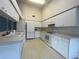 Bright eat-in kitchen featuring white appliances, ample cabinet space, and lots of counterspace at 11213 Brooklawn Dr, Hudson, FL 34667