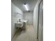 The functional laundry room with utility sink and storage shelves, has a washer and dryer at 11213 Brooklawn Dr, Hudson, FL 34667