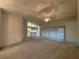 Spacious living room with sliding glass doors providing ample natural light and open access to kitchen at 11213 Brooklawn Dr, Hudson, FL 34667