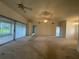 Spacious living room with sliding glass doors providing ample natural light and access to outdoor areas at 11213 Brooklawn Dr, Hudson, FL 34667