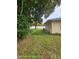 A backyard featuring lush greenery, mature trees, and a well-maintained lawn at 1127 Lodge Cir, Spring Hill, FL 34606