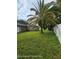 A sprawling backyard showcasing a large palm tree, enhancing the tropical feel of the property at 1127 Lodge Cir, Spring Hill, FL 34606