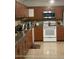 A spacious kitchen featuring wood cabinets, granite countertops, and stainless steel appliances at 1127 Lodge Cir, Spring Hill, FL 34606