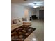 Bright living room features tile flooring, ceiling fan, and neutral paint color with room to entertain at 1127 Lodge Cir, Spring Hill, FL 34606
