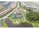 Aerial view of this community showcasing the pool, clubhouse, tennis courts, playground, and water features at 11325 Juglans Dr, Odessa, FL 33556