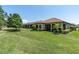 Expansive backyard with lush lawn, mature landscaping, and covered patio, creating a serene outdoor retreat at 11325 Juglans Dr, Odessa, FL 33556