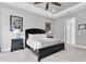 A spacious bedroom features modern furnishings, tray ceilings, and natural lighting at 11325 Juglans Dr, Odessa, FL 33556